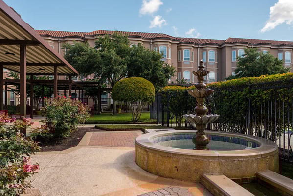 Outdoor garden with a fountain and landscaped area