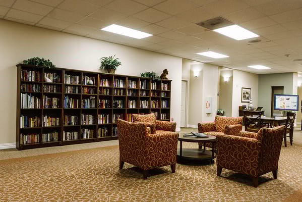 Cozy library area with bookshelves and seating