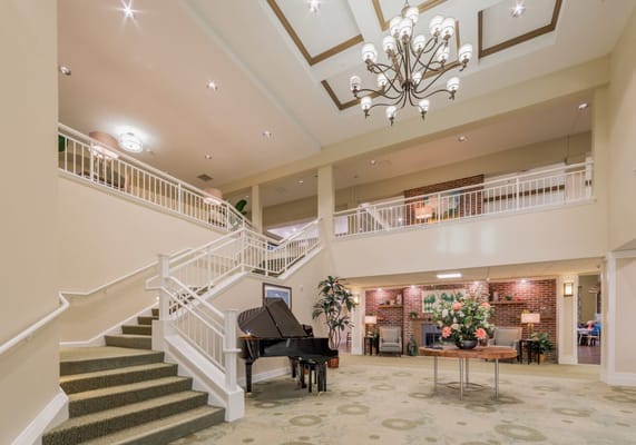 Bright interior lobby with piano and decor
