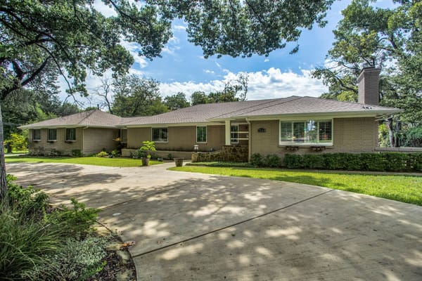 Front view of The Sage Oak of Lakewood surrounded by greenery