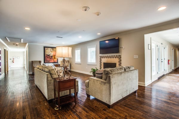 Cozy living room with seating and a lamp at The Sage Oak of Lakewood