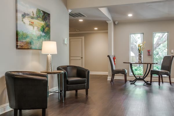 A view of the lobby with chairs, table, and art
