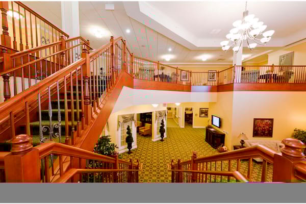Lobby view featuring a wooden staircase and seating area