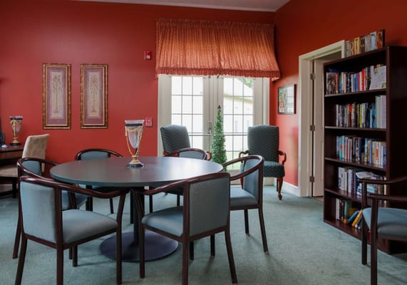 Interior view of a common area with seating and bookshelves
