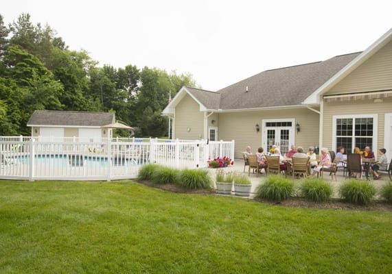 Residents enjoying time outdoors near the pool area.
