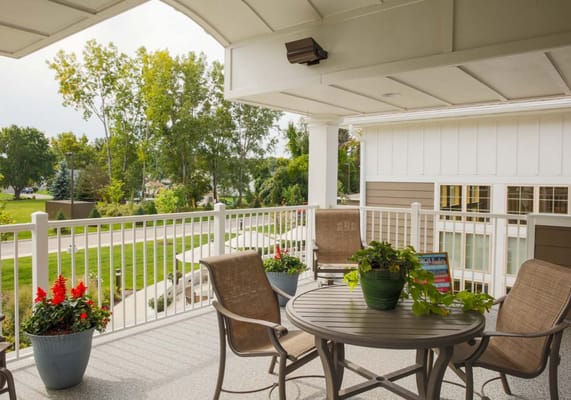 Patio area with seating and plants overlooking garden