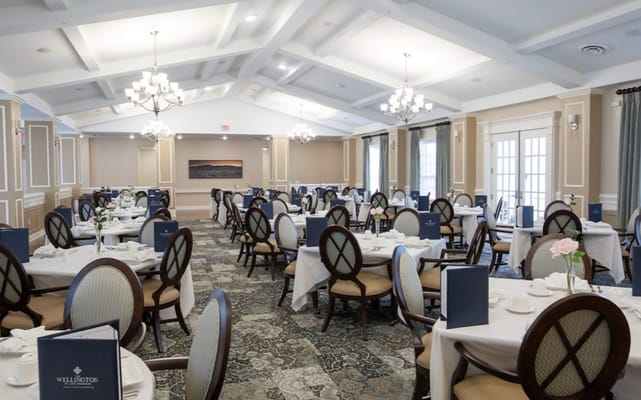 Elegant dining room with tables set for meals at The Wellington at Lake Manassas.