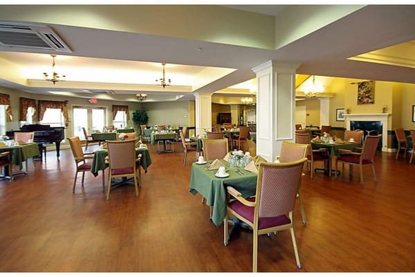 Cozy dining area with tables set for meals at The Woodlands of Hamilton.