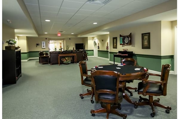 Interior view of the common area with a poker table and seating