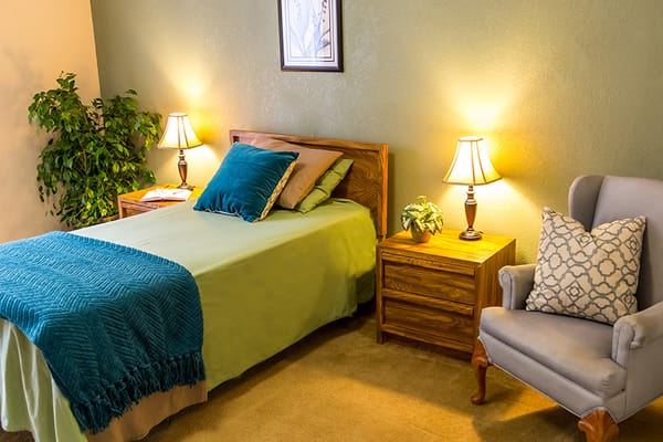 Cozy resident room with bed and seating area