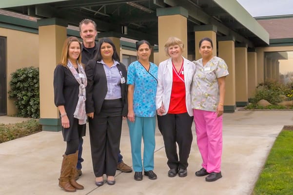 Staff members posing outside the facility