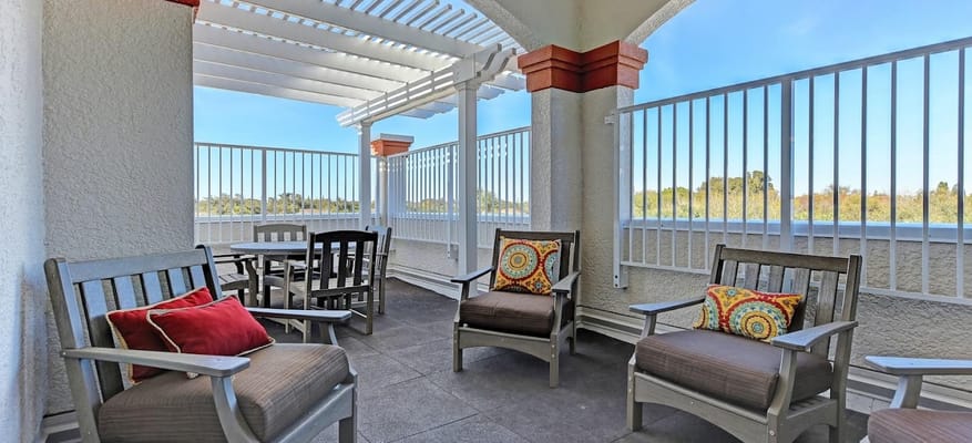 Seating area on the patio with colorful cushions