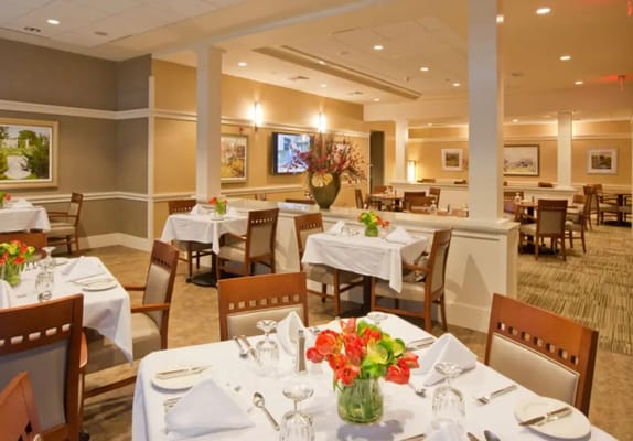 Elegant dining room setup with flowers on the tables