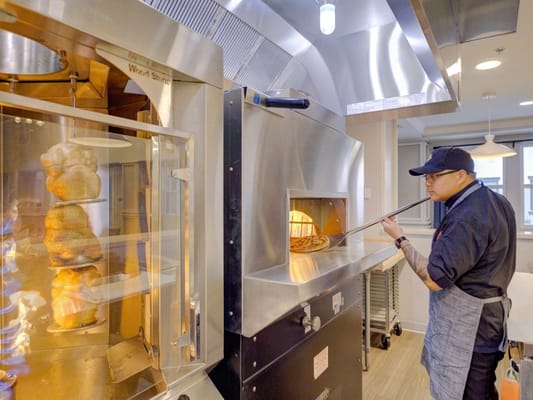Staff preparing food in a kitchen area