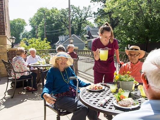 Residents enjoying refreshments on a sunny patio