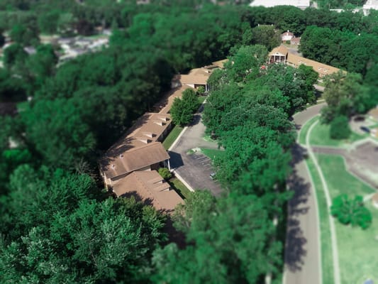 Aerial view of a senior living facility surrounded by trees