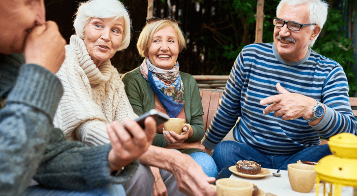 Residents enjoying conversation over coffee in a common area