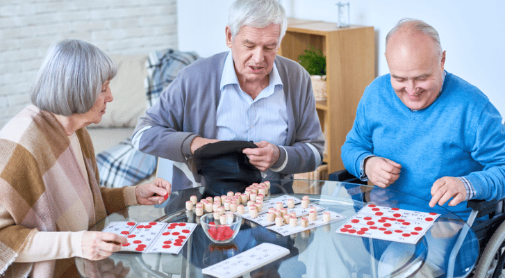Residents playing bingo in a bright common area