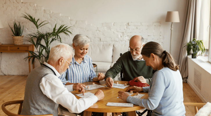 Residents participating in a bingo game in a bright activity room