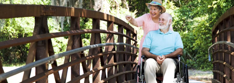 Couple enjoying time on a bridge in a garden