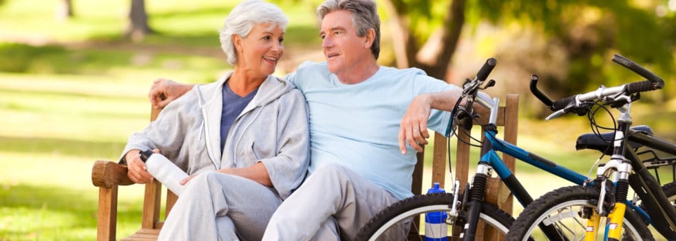 Elderly couple enjoying time together on a park bench