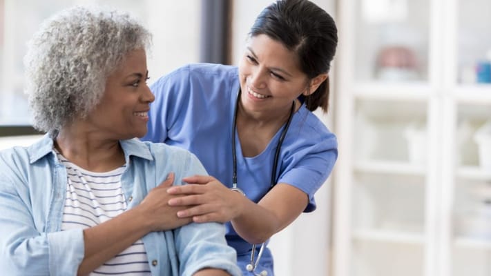 A nurse interacting warmly with a resident