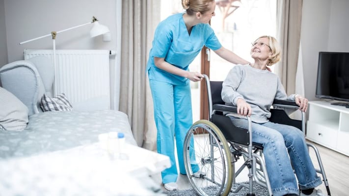 Healthcare worker assisting a resident in a wheelchair