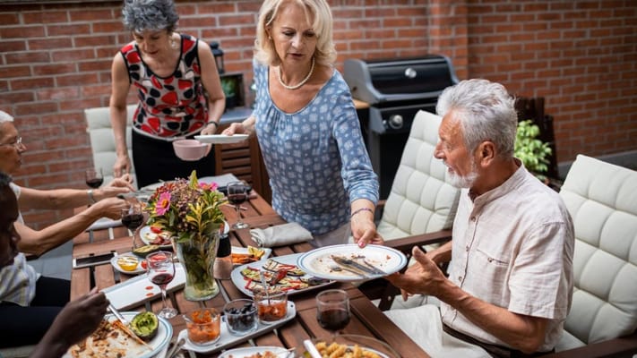 Residents enjoying a meal together outdoors