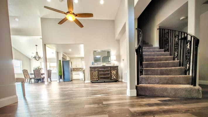 Spacious interior lobby with staircase and dining area