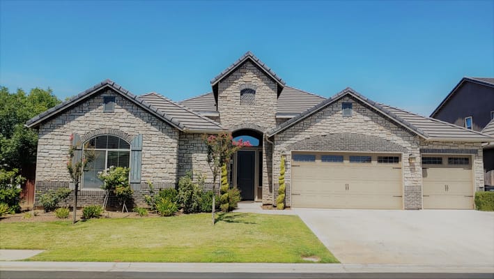 Exterior view of a residential-style building with landscaped yard