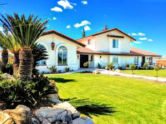 Exterior view of a senior living facility with landscaped garden