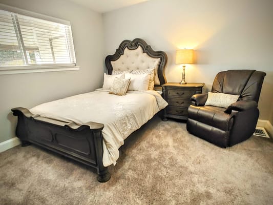 Cozy private resident room with bed and armchair