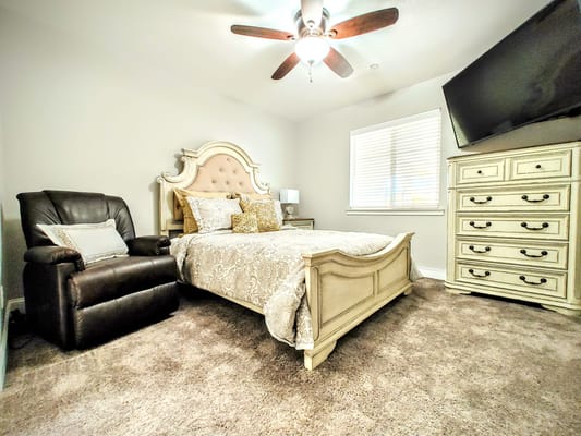 Cozy private room with a bed and recliner