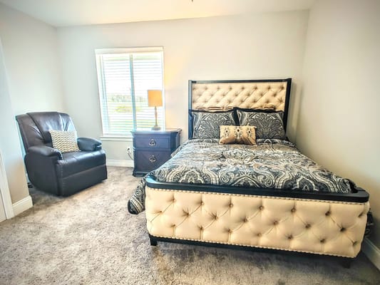 Cozy bedroom with a plush bed and chair
