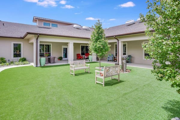 Outdoor seating area with gardens at the facility