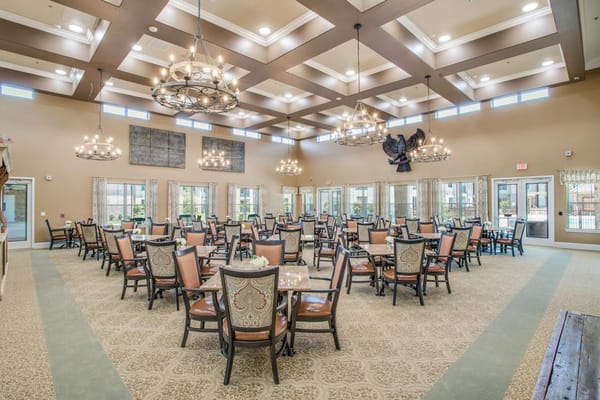 Dining area with tables and chairs, bright lighting