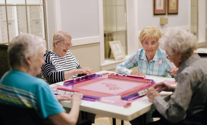 Residents enjoying a game at a table