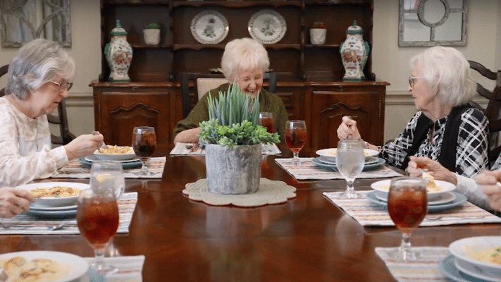 Residents enjoying a meal together at the dining table