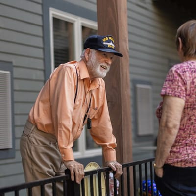 Resident interacting with staff outdoors