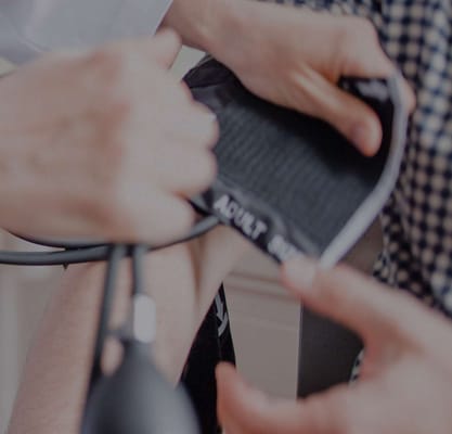 Nurse checking a resident's blood pressure