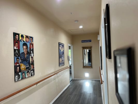 A hallway with framed celebrity posters on the walls