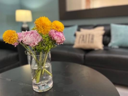 A decorative vase with flowers on a coffee table