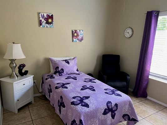 Cozy resident room with a bed and armchair