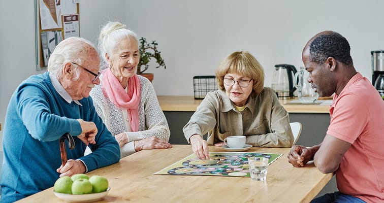 Residents playing a board game in a common area