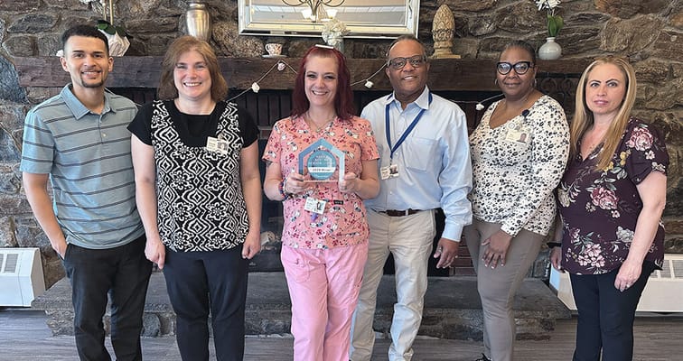 Staff members celebrating an award in a common area