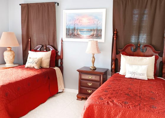 Cozy shared bedroom with two beds and decorative pillows