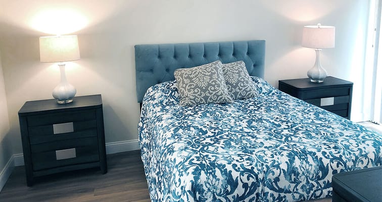 Cozy private room with decorative bedspread and lamps