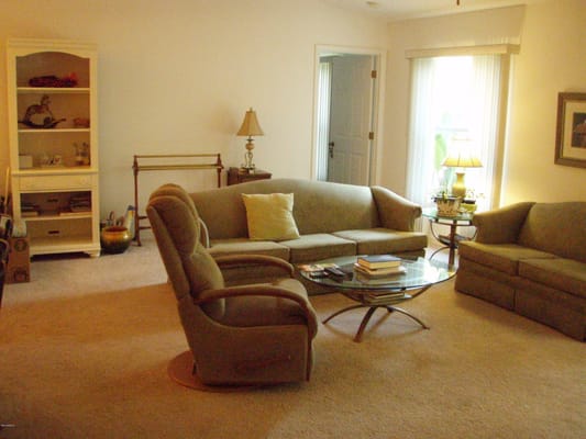 Comfortable living room with sofas and a glass coffee table
