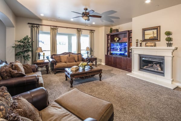 Bright common area with comfortable seating and a fireplace