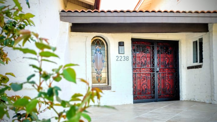 Exterior view of a building entrance with decorative doors